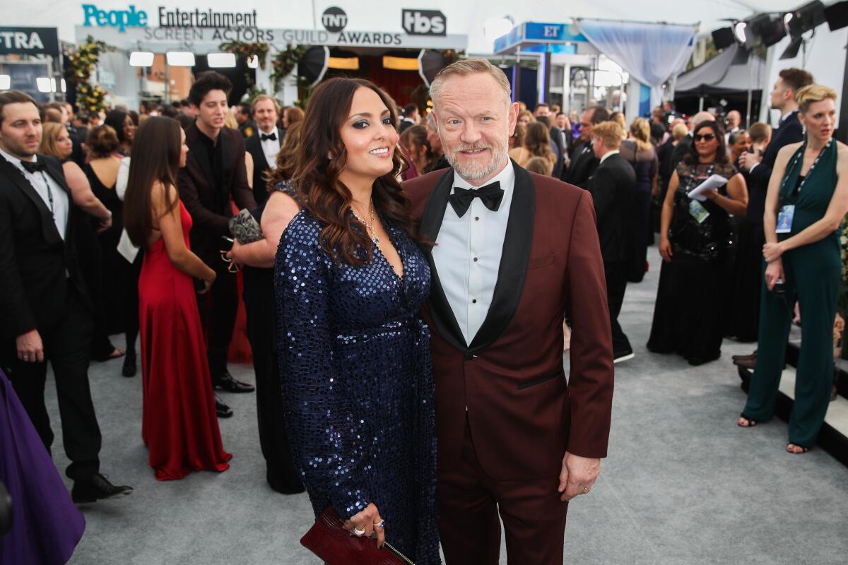 At the 26th Screen Actors Awards, Jared Harris, with wife Allegra Riggio, looks dapper in a dark rust-colored tuxedo from Hugo.