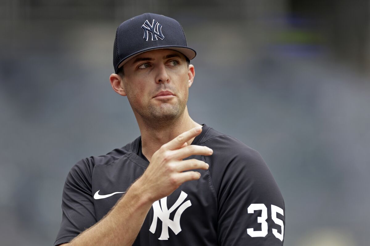 New York Yankees pitcher Clay Holmes speaks to a reporter on the field before the first baseball game of a doubleheader against the Los Angeles Angels on Thursday, June 2, 2022, in New York. The 29-year-old right-hander has gone from worst to first in the standings and from off the big league roster to a possible All-Star appearance. (AP Photo/Adam Hunger)