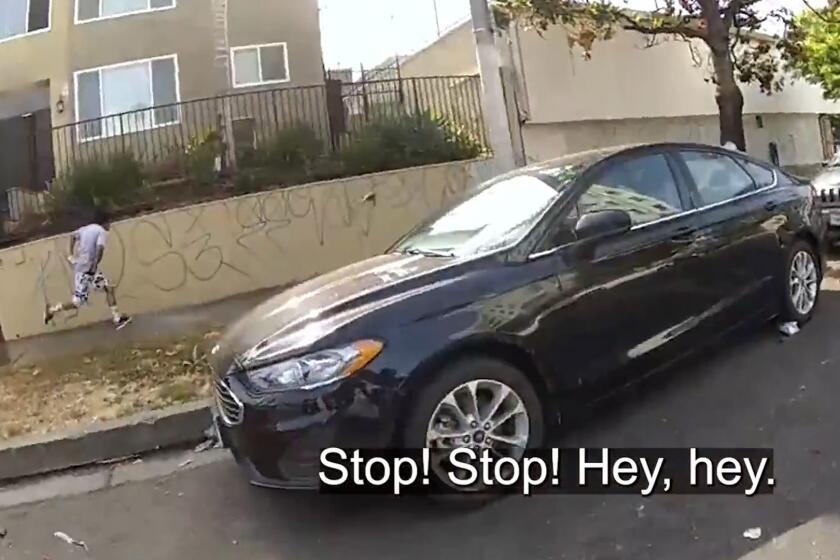 Los Angeles police say that 23-year-old Marvin Cua pointed a gun at officers before he was fatally shot in Koreatown last month, but newly-released body camera footage doesn't capture him doing so and shows an officer shooting Cua as he flees. (Los Angeles Police Department)