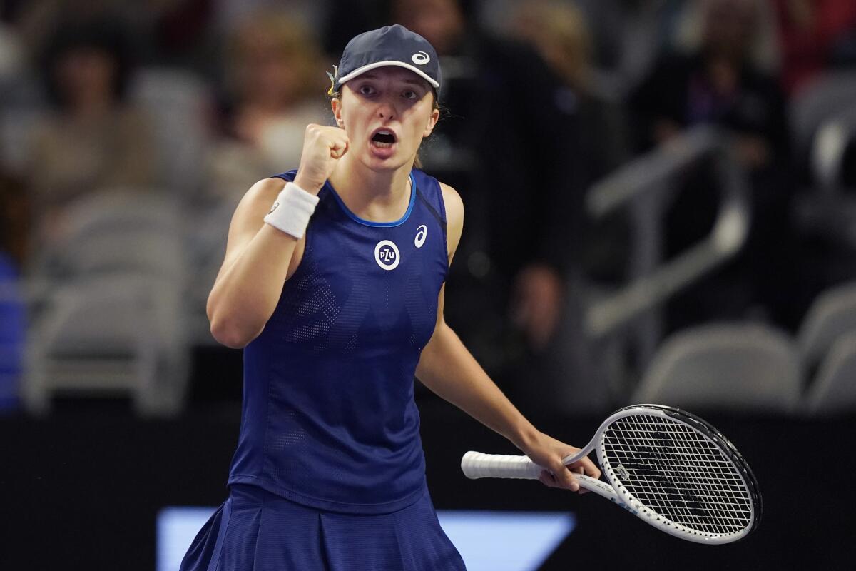 Iga Swiatek reacts after scoring a point during a match against Coco Gauff at the WTA Finals in November.