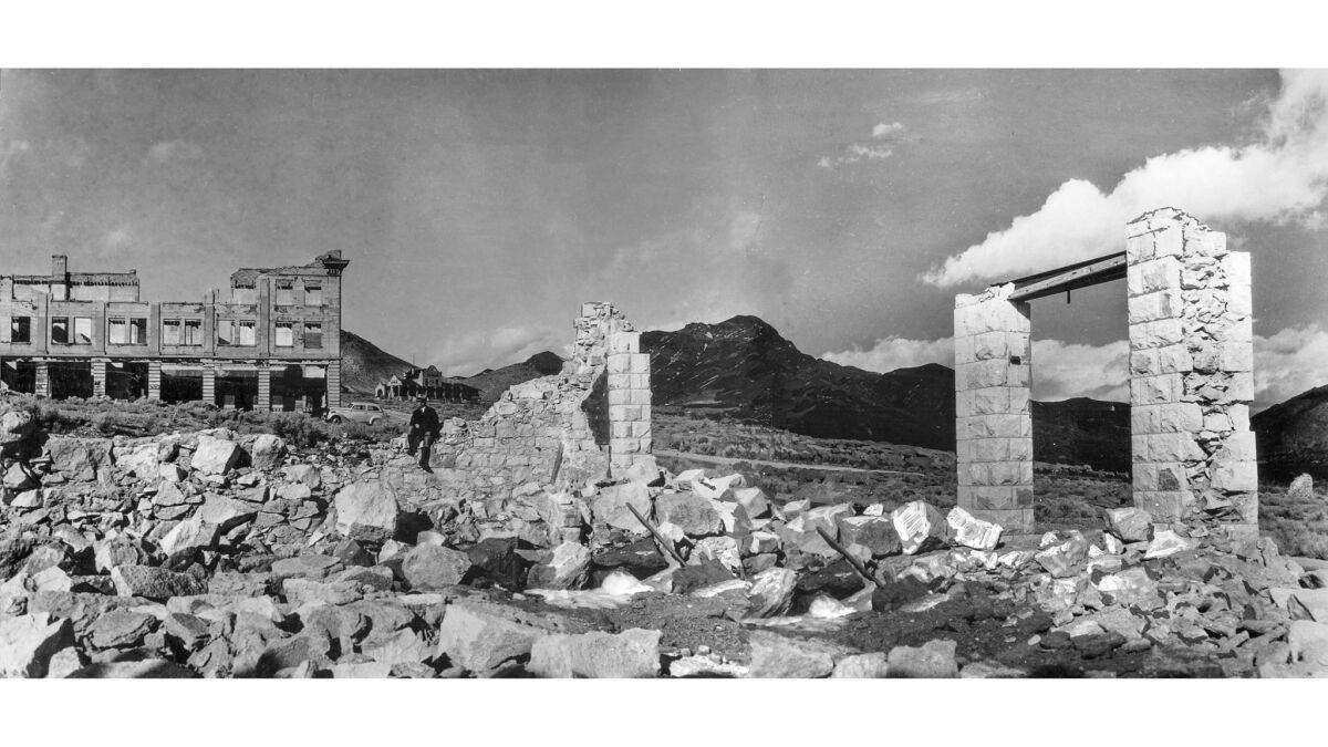 Feb. 1937: Ruins of the ghost town of Rhyolite, Nev. This panoramic image was made from two separate photographs.