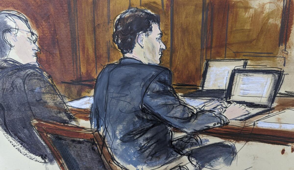 A courtroom sketch of Sam Bankman-Fried at a table with his lawyer.
