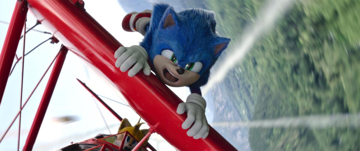 A blue cartoon hedgehog holding onto a red plane in flight