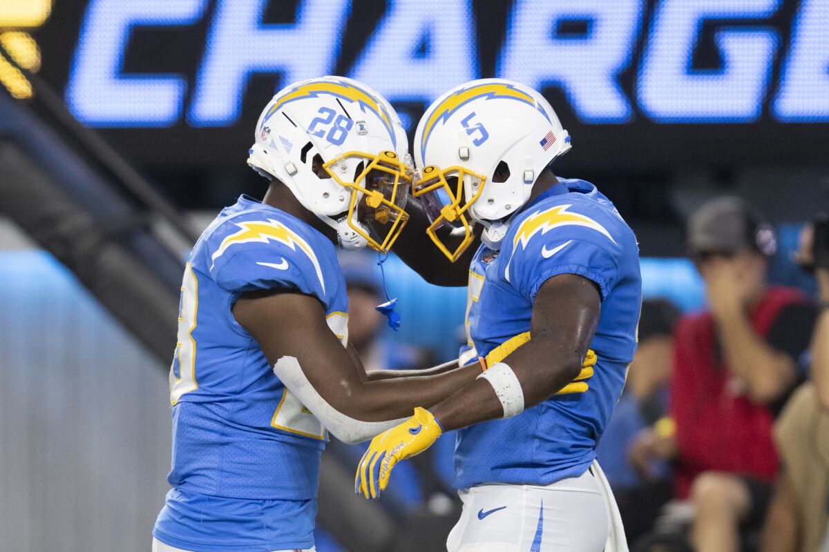 Los Angeles Chargers wide receiver Joshua Palmer (5) celebrates his touchdown with running back Isaiah Spiller (28).
