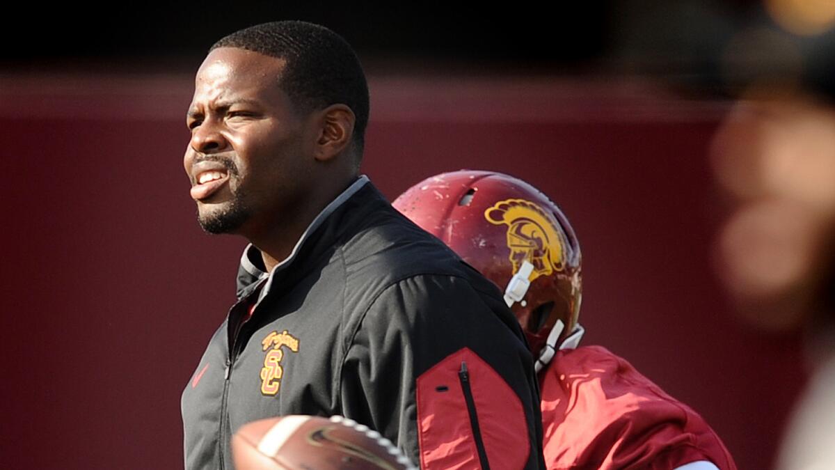 Kenechi Udeze helps conduct practice in preparation for the Trojans' bowl game.