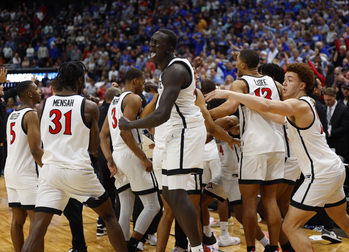 San Diego State's Aguek Arop, center, and the Aztecs celebrate after the game was over in a 57-56 victory over Creighton.