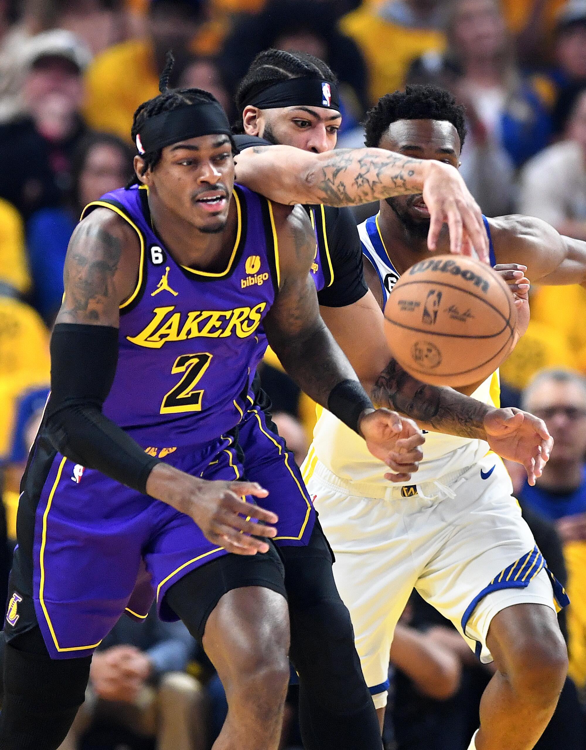 Lakers forward Jarred Vanderbilt, left, and forward Anthony Davis battle for a loose ball.