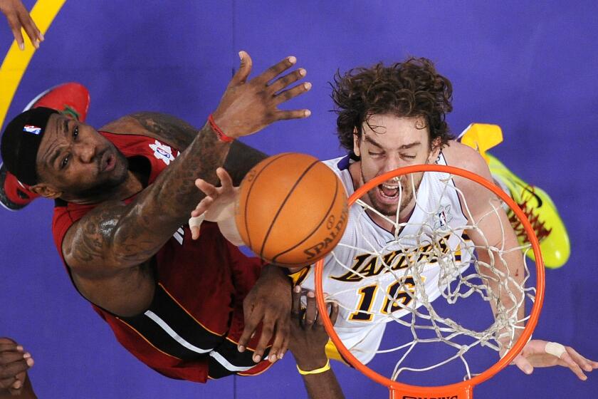 Miami Heat forward LeBron James, left, and Los Angeles Lakers power forward Pau Gasol of Spain reach for a rebound during the first half of their NBA basketball game, Saturday, Dec. 25, 2010, in Los Angeles. The Heat won 96-80. (AP Photo/Mark J. Terrill)