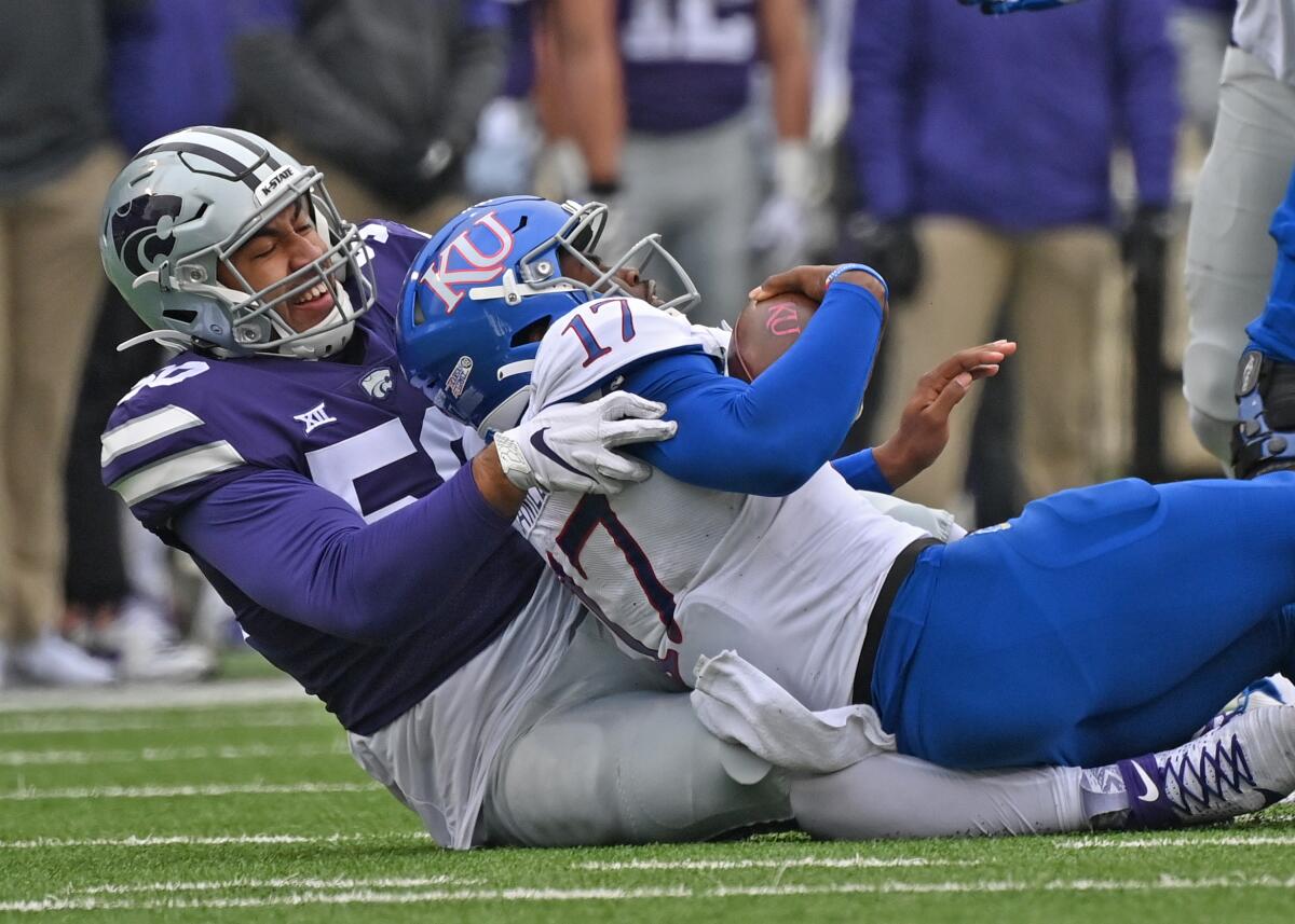 Kansas State defensive end Tyrone Taleni sacks Kansas quarterback Jalon Daniels.