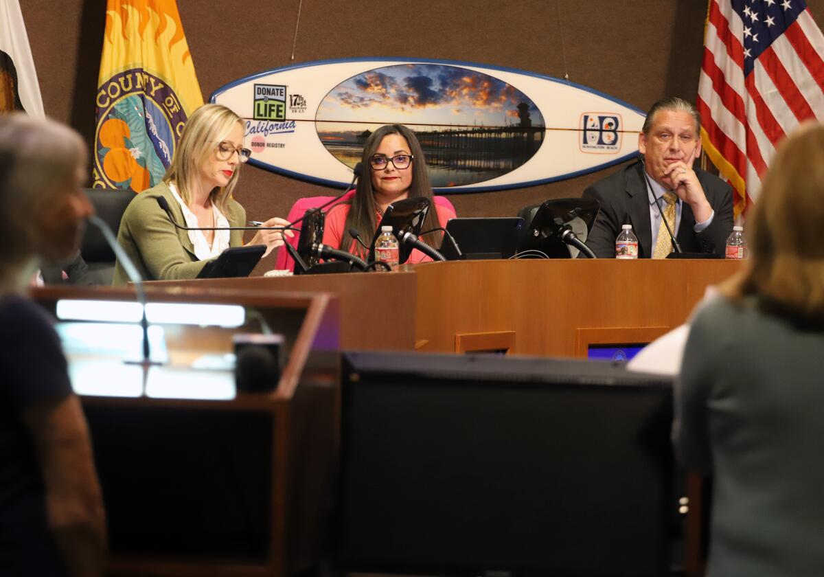 Huntington Beach Mayor Gracey Van Der Mark, center, shown last October, spearheaded the library book review resolution.