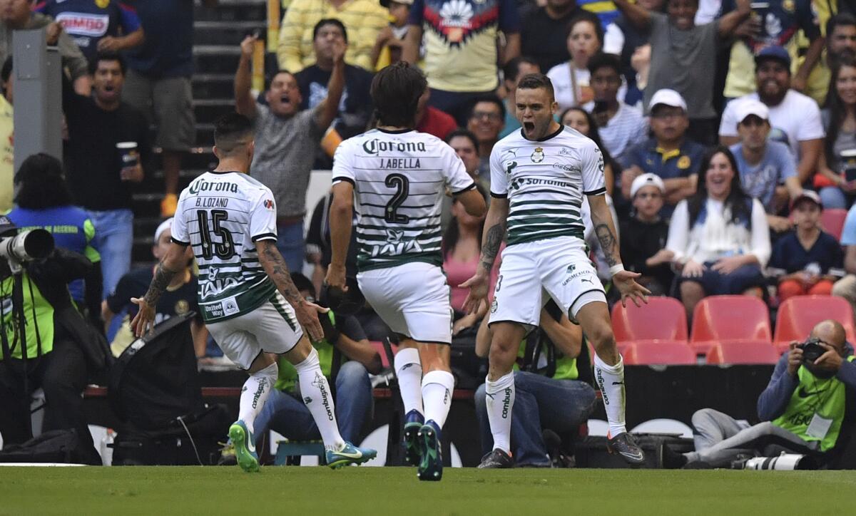Santos' forward Jonathan Rodriguez (R) celebrates with teammates after scoring a goal against America during their semi-final secong leg football match of Clausura Mexican tournament at the Azteca stadium in Mexico City, on May 13, 2018.