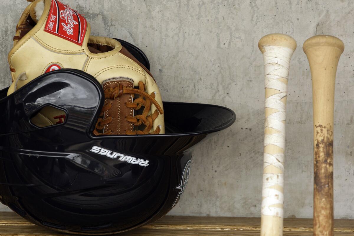 Baseball gear in a dugout.