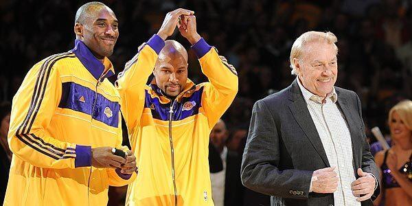 Jerry Buss takes center stage, along with Lakers guards Kobe Bryant and Derek Fisher, during the team's ring ceremony after claiming their 16th NBA championship the previous spring.