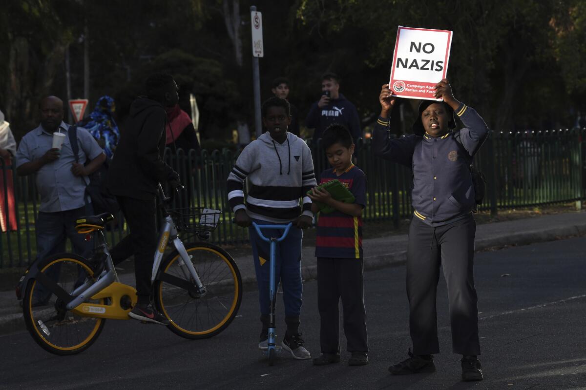 A young boy carries a placard titled "No Nazis" during a demonstration in Melbourne on Dec. 4, 2017. Australia's Victoria state is drafting legislation that would make it the first in the country to ban the public display of Nazi symbols as local neo-Nazi activity increases. (James RossAAP Image via AP)