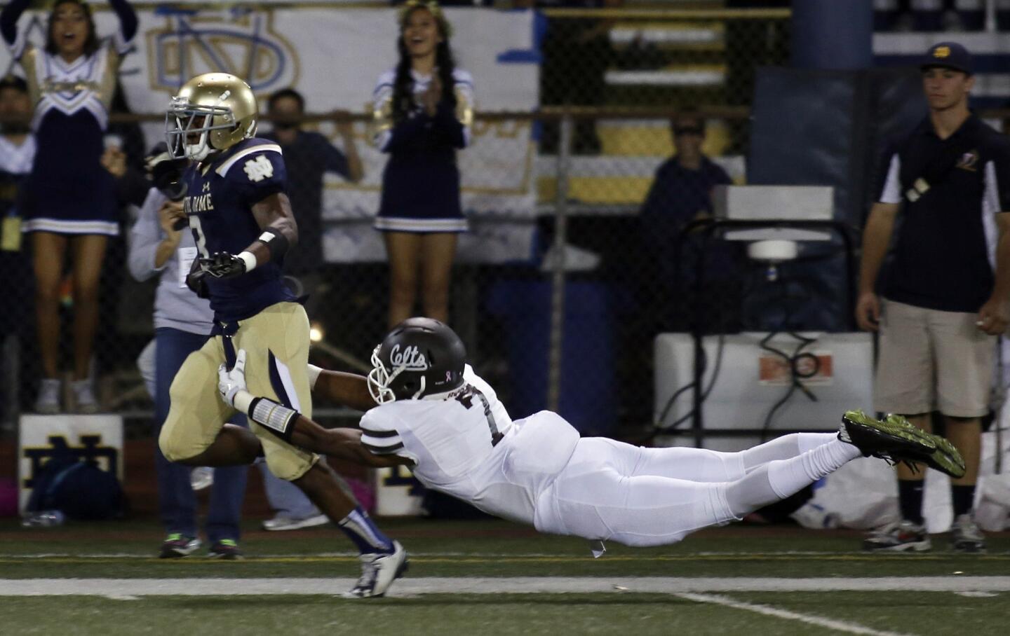 Notre Dame returner C.J. Sanders eludes the tackle attempt of Crespi's Marvell Tell for a touchdown on the opening kickoff.