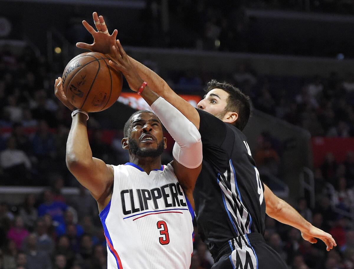 Los Angeles Clippers guard Chris Paul, left, shoots as Minnesota Timberwolves guard Ricky Rubio defends during the first half on Wednesday.