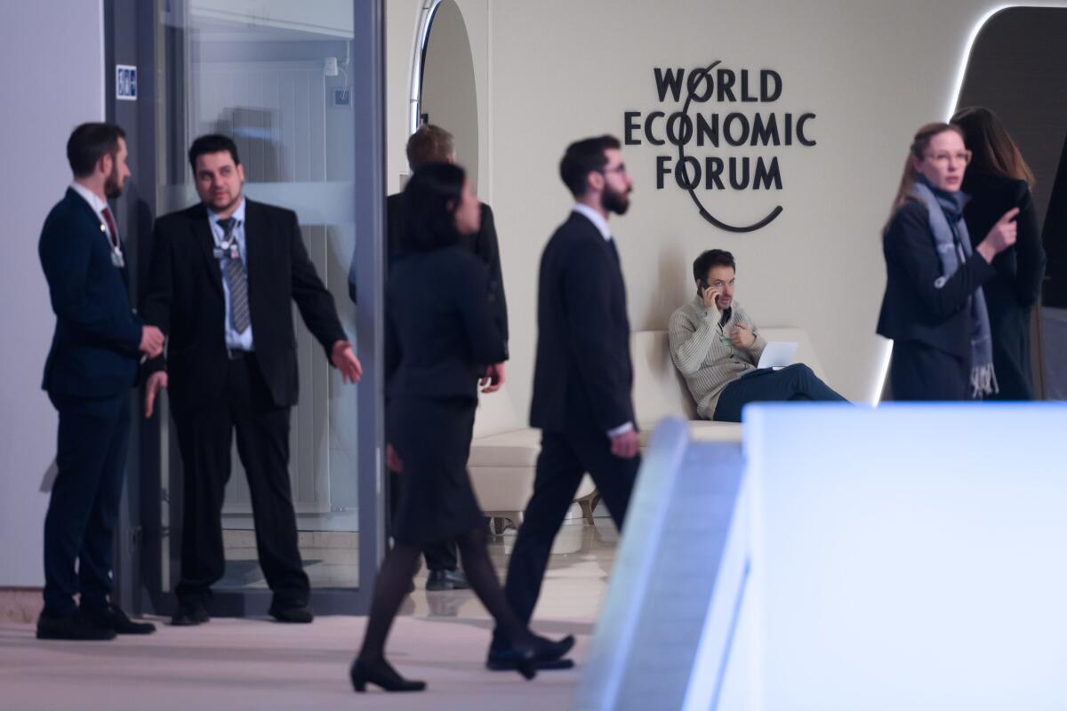Staff members circulate at the Davos conference center on Monday before the annual meeting of the World Economic Forum.