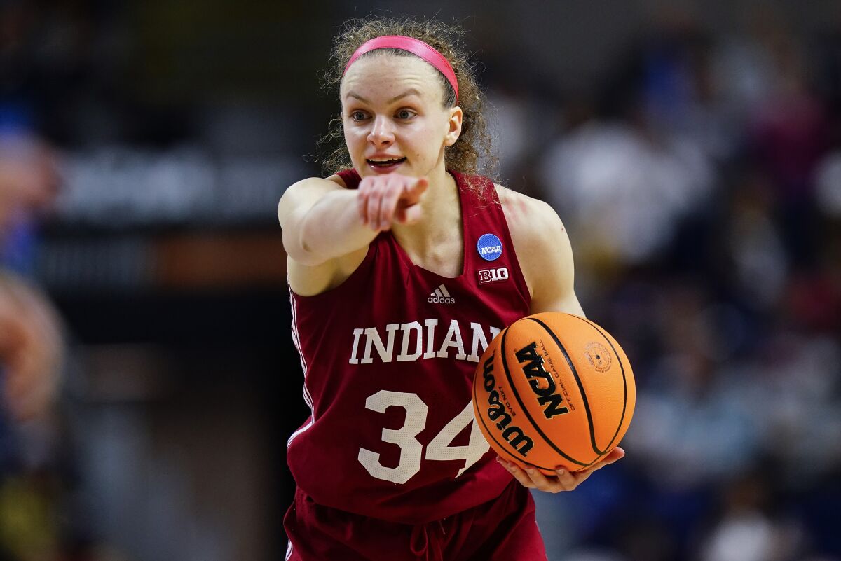 FILE - Indiana guard Grace Berger (34) motions to teammates during the fourth quarter of a college basketball game against Connecticut in an NCAA women's tournament regional semifinal March 26, 2022, in Bridgeport, Conn. Berger suffered a right knee injury Friday against Auburn. (AP Photo/Frank Franklin II, File)