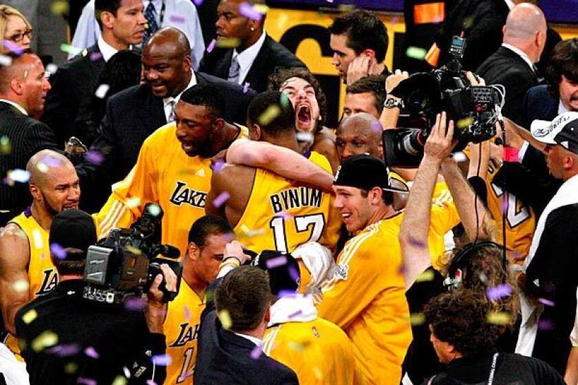 Big men Pau Gasol and Andrew Bynum embrace in the middle of the Lakers' celebration on the Staples Center court following an 83-79 victory over the Boston Celtics in Game 7 of the NBA Finals on Thursday night.