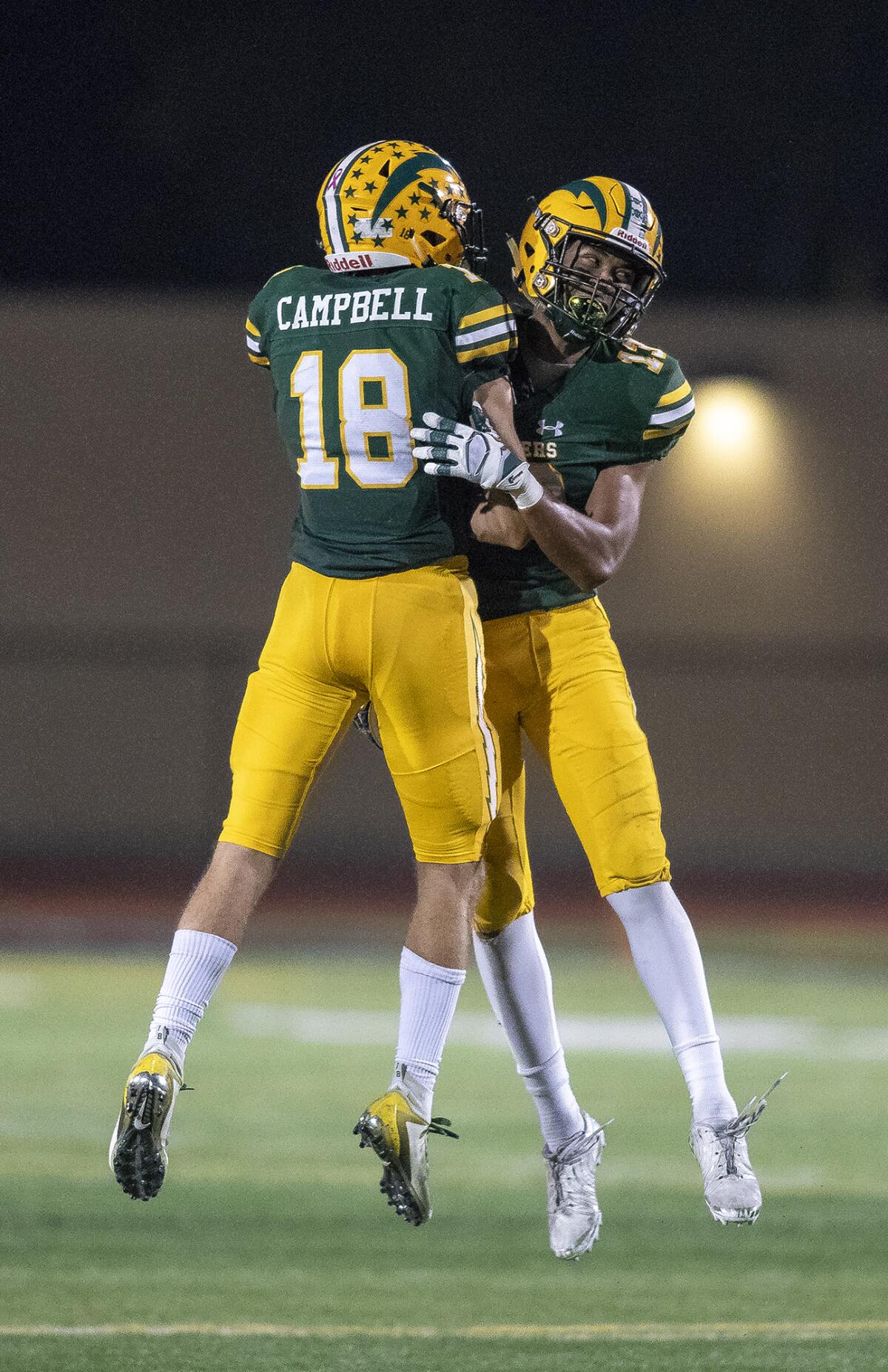 Edison's PJ Campbell, left, and Cole Koffler celebrate after beating Heritage 42-27 in the first round of the CIF Southern Section Division 3 playoffs at Huntington Beach High on Nov. 8.