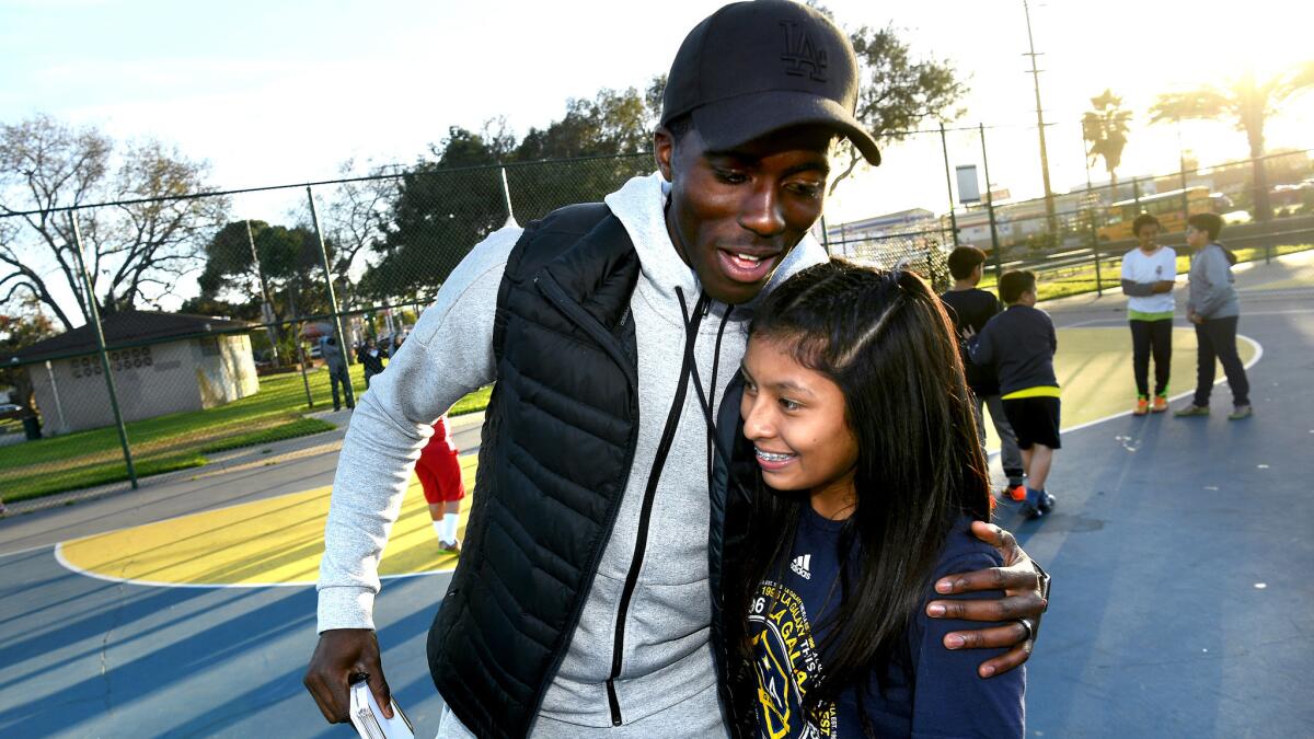 Former Galaxy star Gyasi Zardes shares a personal moment with Brittany Rodriguez, 15, during a goodbye ceremony at Hawthorne Memorial Park.