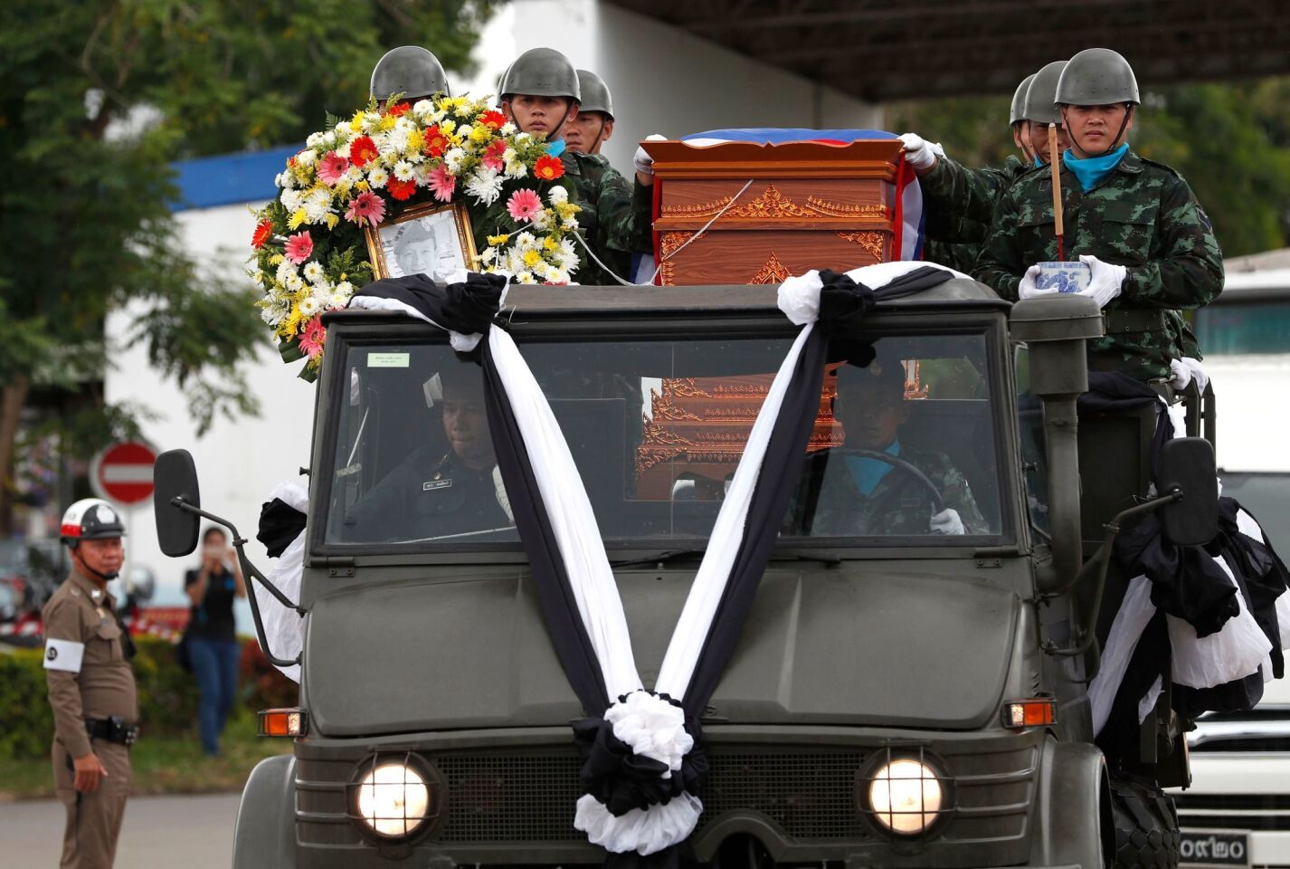 Thai military honor guards transport a coffin containing the remains of former Thai Navy Seal Petty Officer 1st Class Saman Gunan, who died in the Tham Luang cave rescue operations.