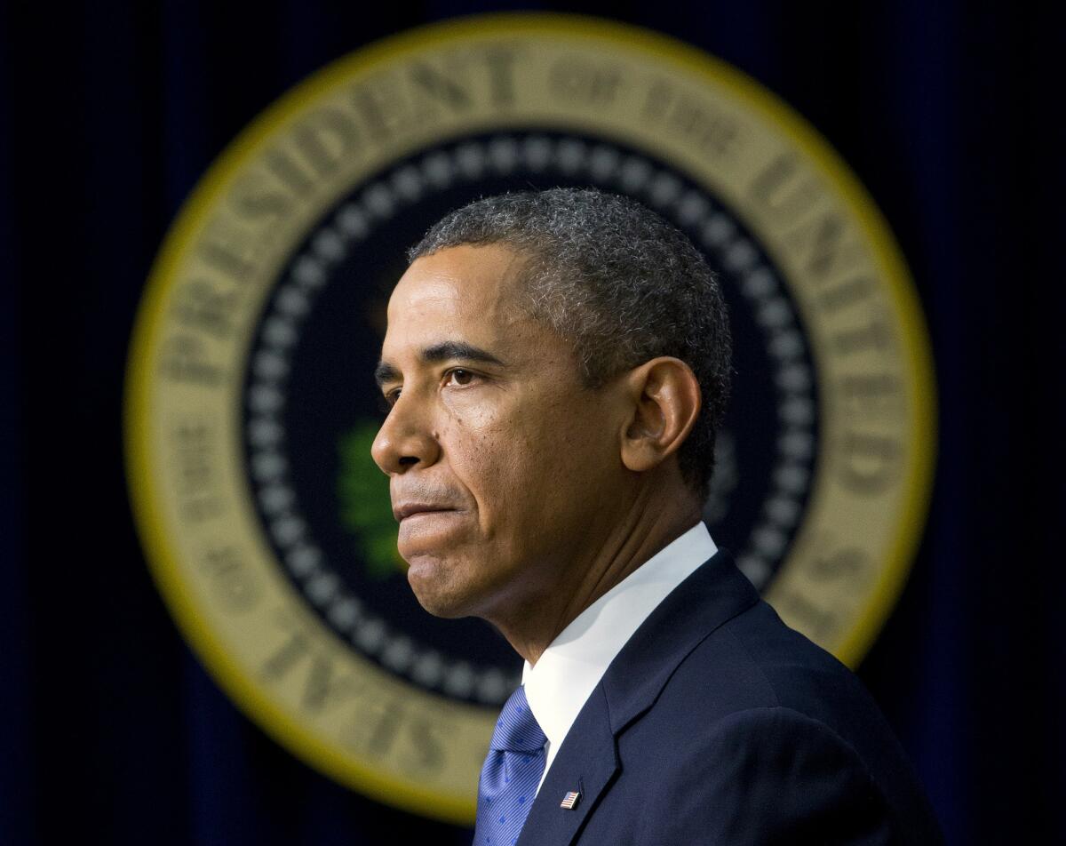 President Obama pauses as he speaks in the South Court Auditorium in the White House complex.