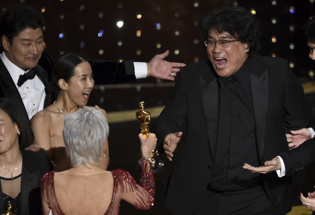 Even Bong Joon Ho, right, acts surprised. The Korean producer reacts as he is presented with the award for best picture for "Parasite" from presenter Jane Fonda at the Oscars on Feb. 9, 2020.