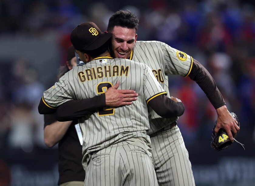 Joe Musgrove hugs Trent Grisham after pitching a no-hitter against the Texas Rangers on Friday.