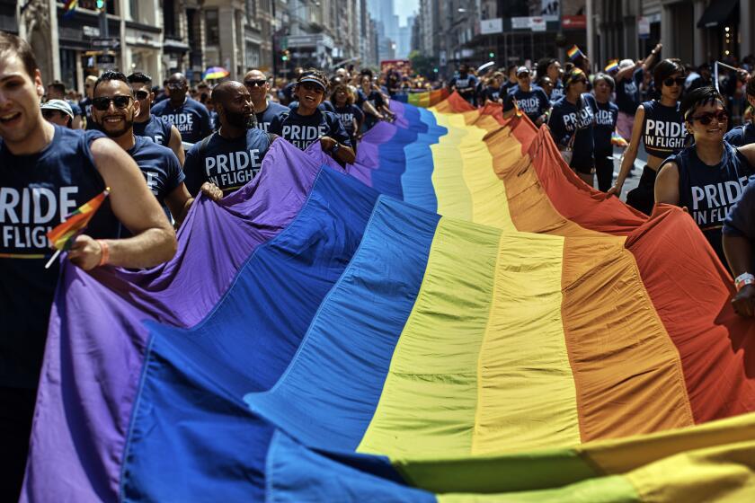 FILE - Reveler carry a LTBGQ flag along Fifth Avenue during the New York City Pride Parade on Sunday, June 24, 2018, in New York. Parades celebrating LGBTQ pride kick off in some of America's biggest cities Sunday amid new fears about the potential erosion of freedoms won through decades of activism. The annual marches in New York, San Francisco, Chicago and elsewhere take place just two days after one conservative justice on the Supreme Court signaled, in a ruling on abortion, that the court should reconsider the right to same-sex marriage recognized in 2015. (AP Photo/Andres Kudacki, File)