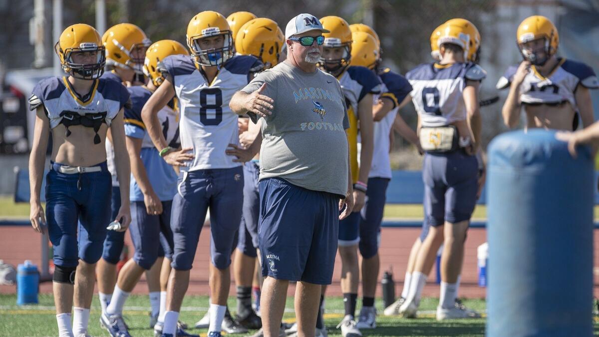 Coach Jeff Turley, shown giving his players instructions on Aug. 8, has led Marina High to two straight victories.