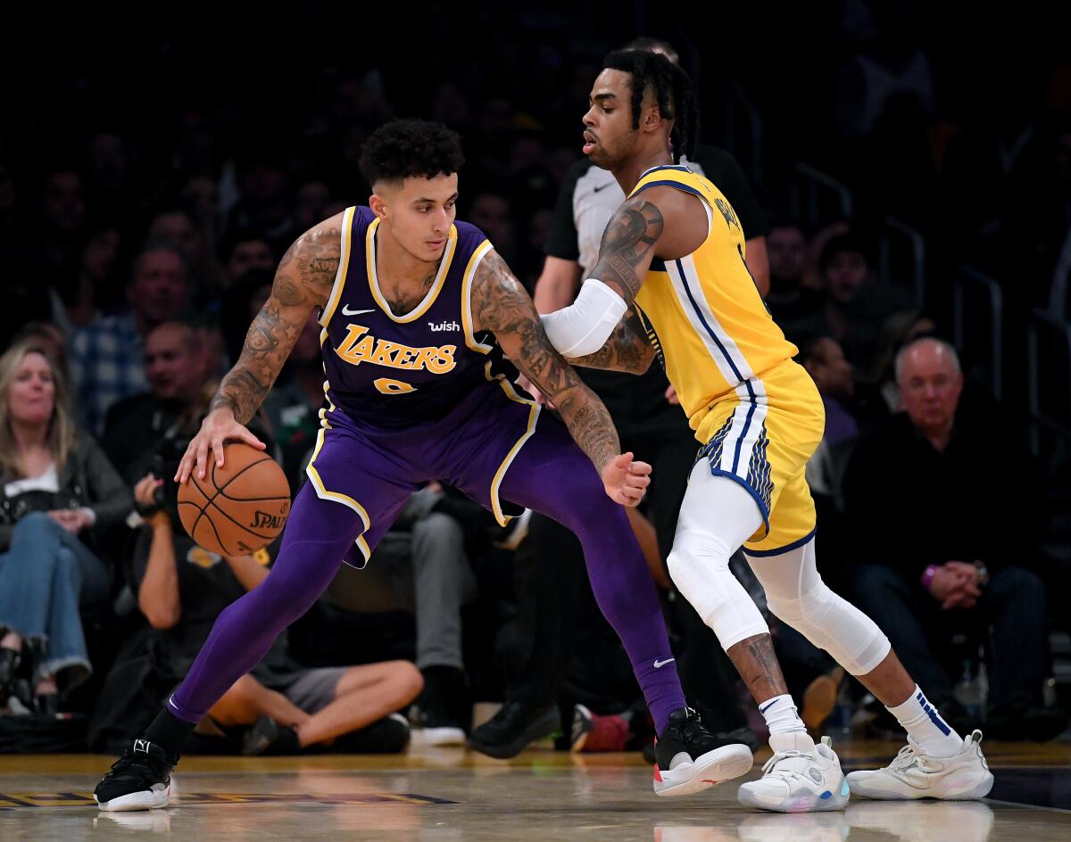 LOS ANGELES, CALIFORNIA - NOVEMBER 13: Kyle Kuzma #0 of the Los Angeles Lakers posts up D'Angelo Russell #0 of the Golden State Warriors during a 120-94 Lakers win at Staples Center on November 13, 2019 in Los Angeles, California. NOTE TO USER: User expressly acknowledges and agrees that, by downloading and/or using this photograph, user is consenting to the terms and conditions of the Getty Images License Agreement. (Photo by Harry How/Getty Images) ** OUTS - ELSENT, FPG, CM - OUTS * NM, PH, VA if sourced by CT, LA or MoD **