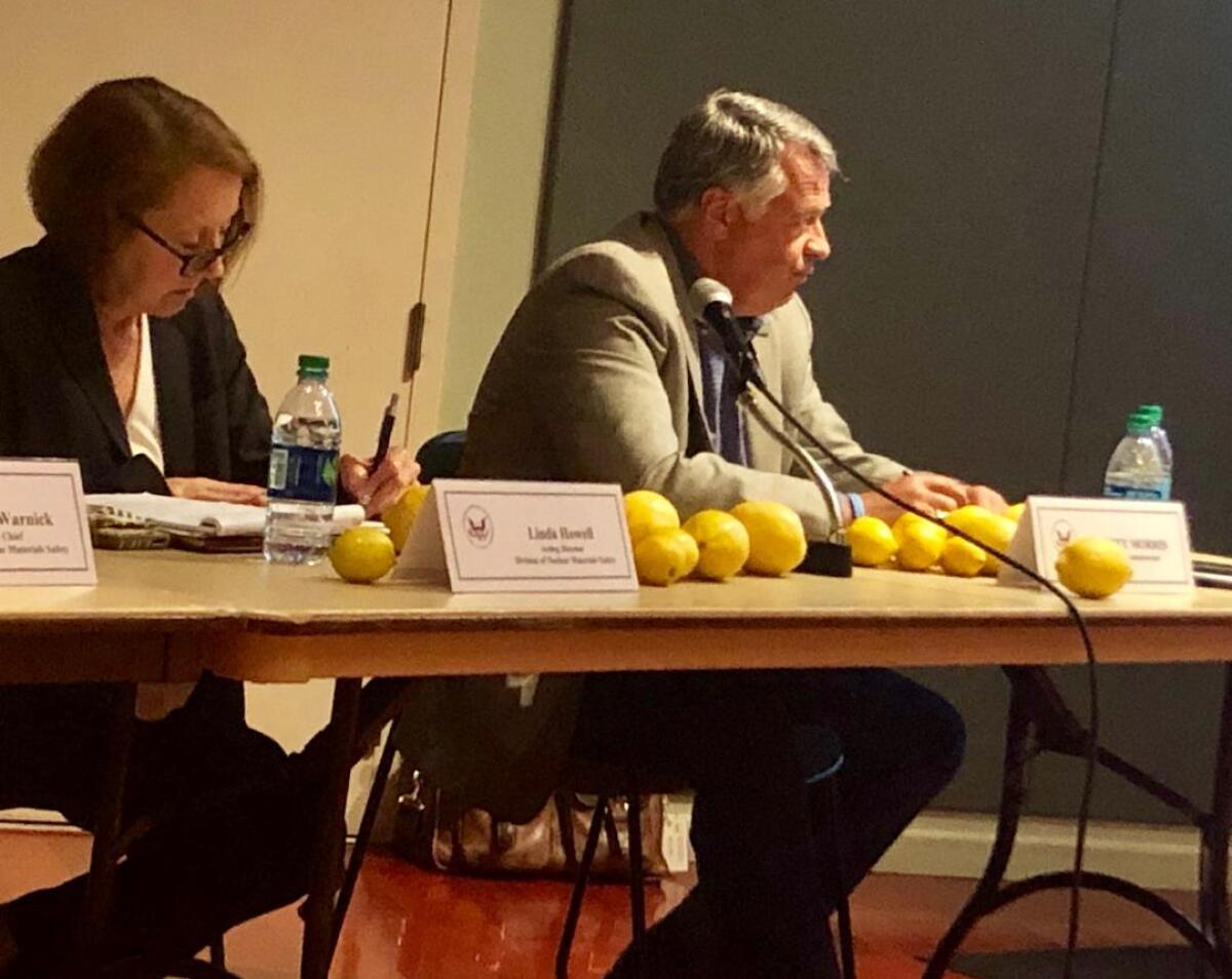 Some attendees at a town hall hosted by the U.S. Nuclear Regulatory Commission in San Juan Capistrano placed lemons on the table of NRC officials Linda Howell (left) and Scott Morris. Critics of a recently constructed dry storage facility at the San Onofre Nuclear Generating Station have called the design a lemon.