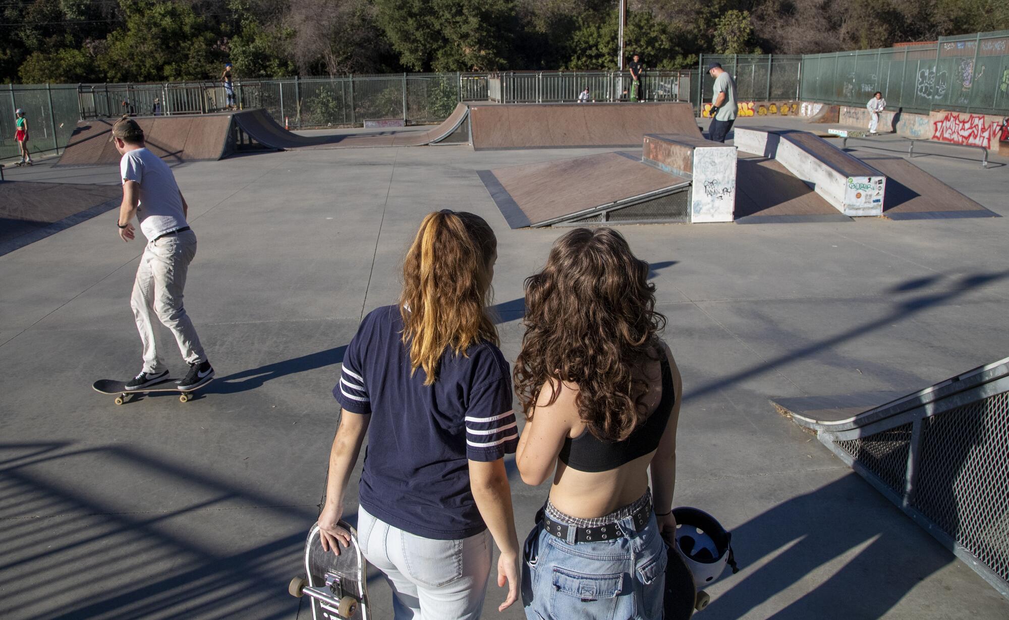 Aunt Skatie crew leader Maggie Bowen, left, and Ava Van Vechten check out the scene at South Pasadena Skate Park.