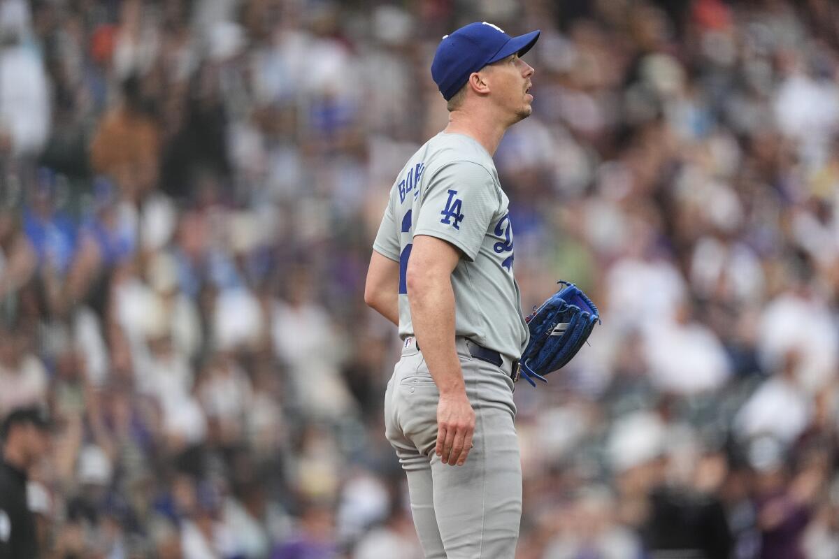 Los Angeles Dodgers right-hander Walker Buehler with a gray away uniform and blue glove