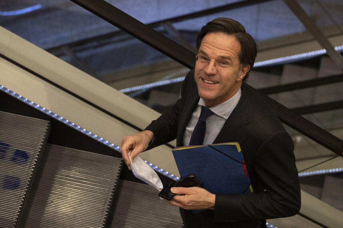 FILE - In this file photo dated Friday, April 2, 2021, caretaker Dutch Prime Minister Mark Rutte leaves after surviving a no-confidence motion in parliament in The Hague, Netherlands. The four parties negotiating to form the next ruling Dutch coalition in The Hague, Monday, Dec. 13, 2021, plan to send a policy blueprint for the next term of government to lawmakers this week, marking another step toward the end of marathon talks that followed a March election. (AP Photo/Peter Dejong, FILE)