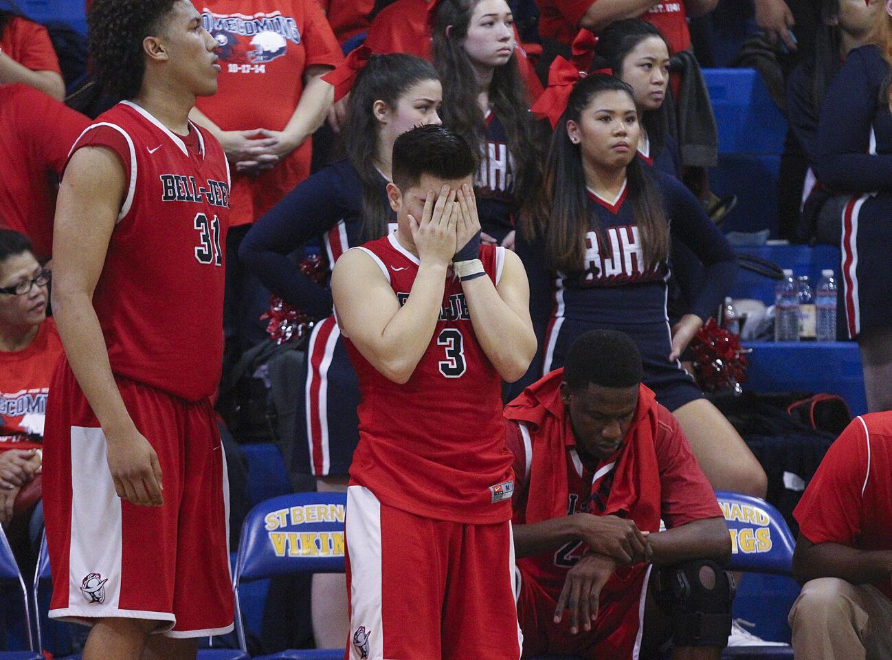 Bell-Jeff's Marco Escribano covers his face in despair as the game comes to an end with a loss against St. Bernard in the CIF Division V-A boys basketball semifinal game at St. Bernard High School in Playa Del Rey on Friday, February 27, 2015. Bell-Jeff lost the game.