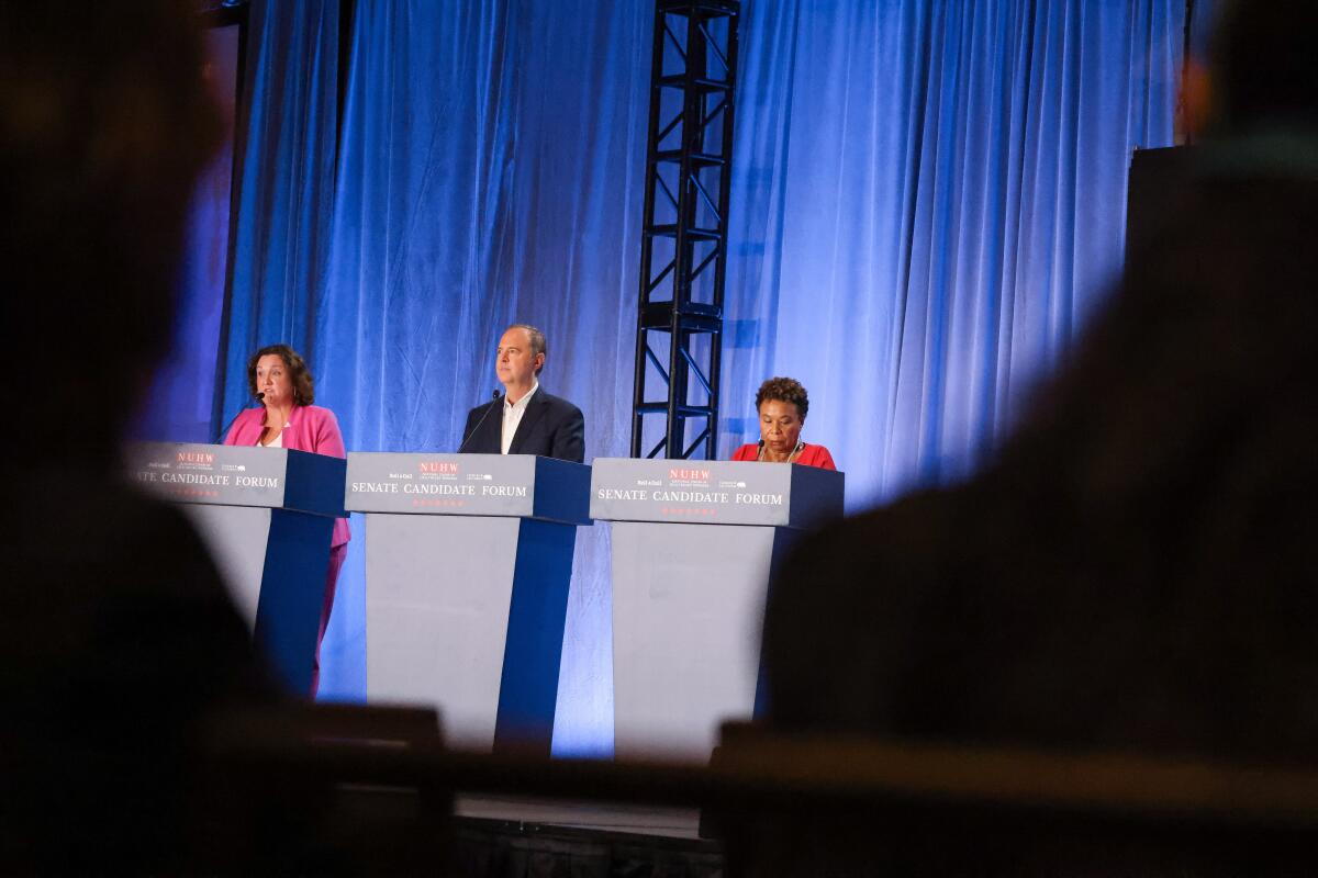  Rep. Katie Porter, Rep. Adam Schiff, and Rep. Barbara Lee, left to right participate in a debate on stage 