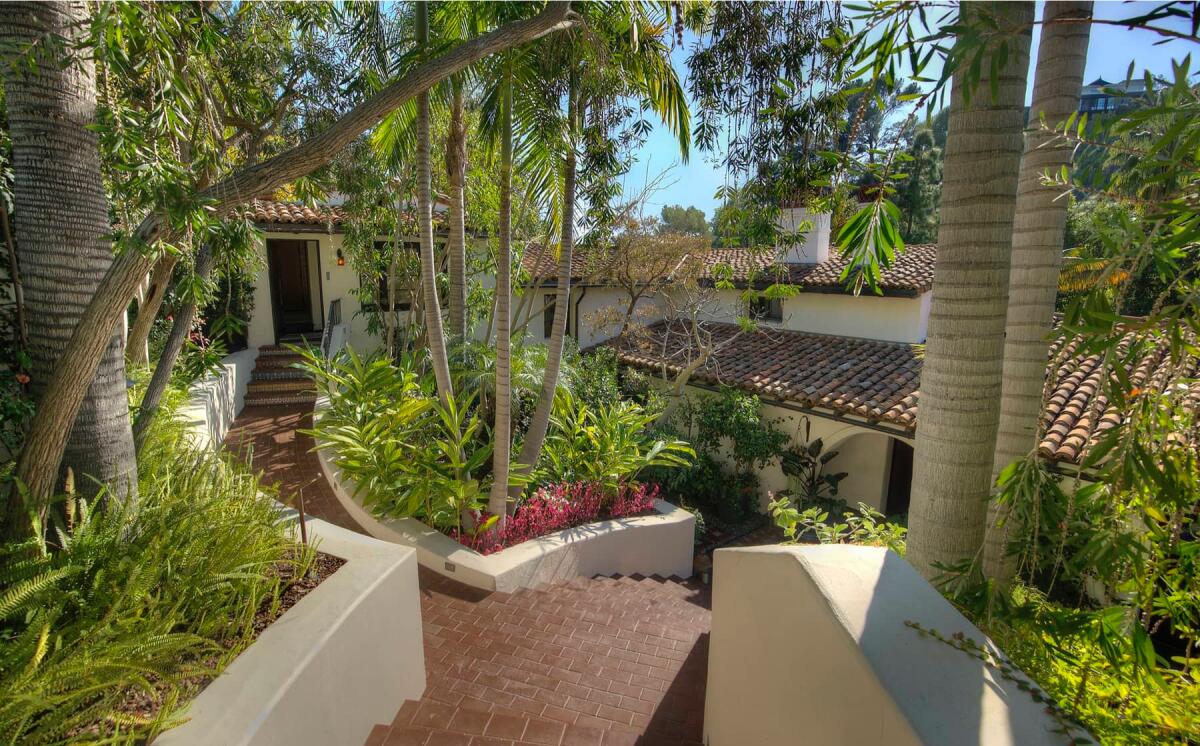 A view toward one of the doors of the villa with gardens all around. 