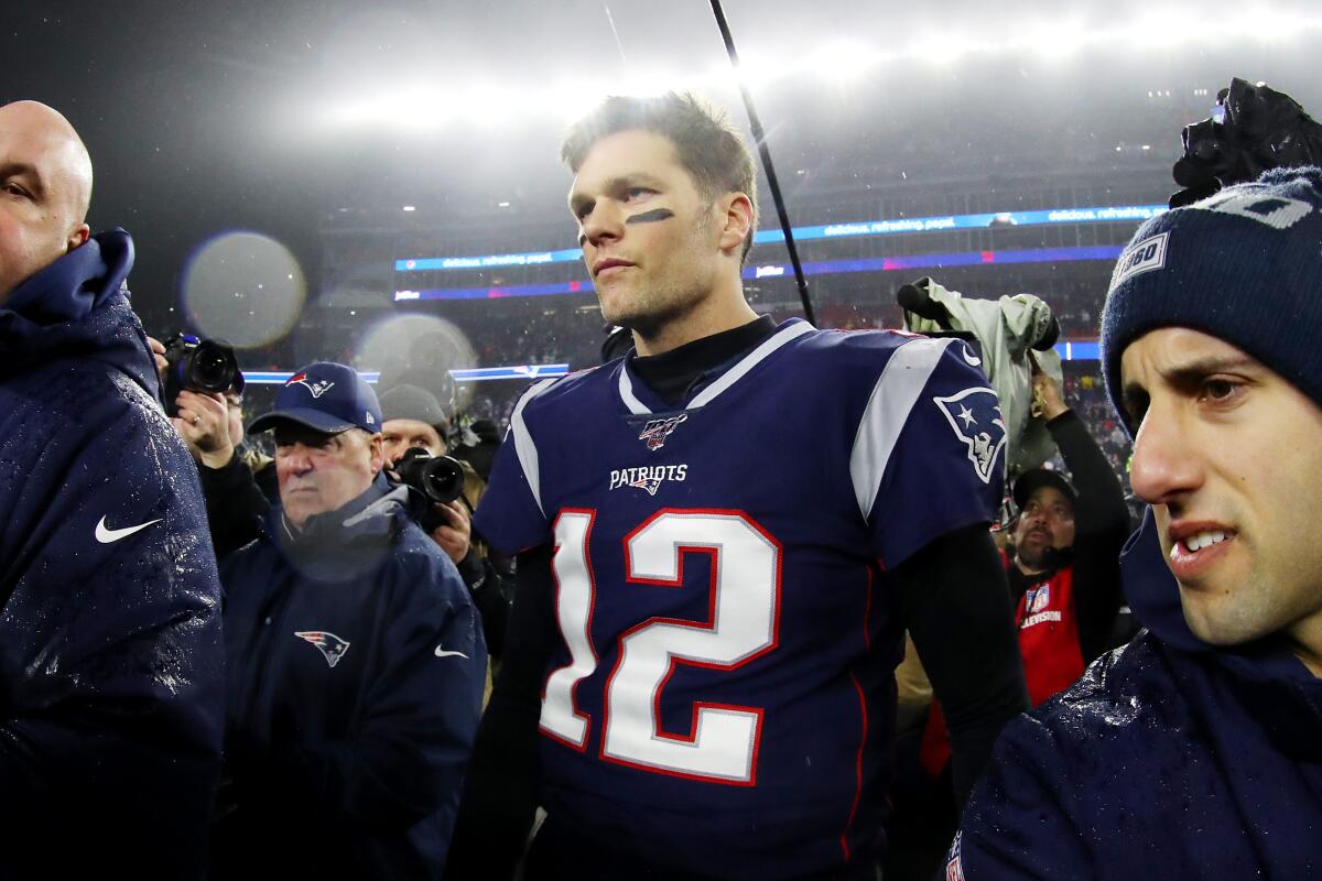 Patriots quarterback Tom Brady walks off the field.