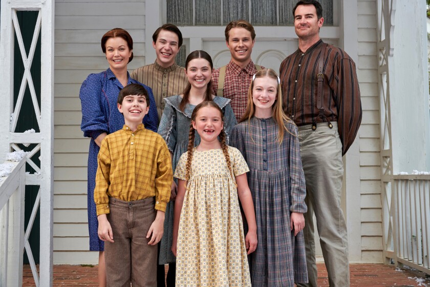 A family smiles for the camera in a scene from “The Waltons’ Homecoming”