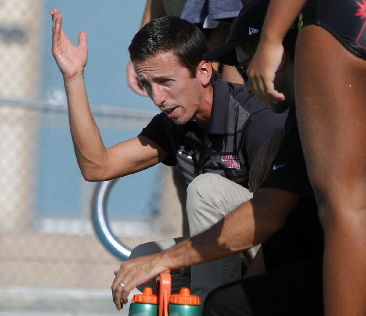 Glendale's head coach Narek Vardanian talks with his team during a timeout in the match against Burroughs in a Pacific League boys' water polo match at Burroughs High School on October 1, 2019. Glendale won the match 10-8.