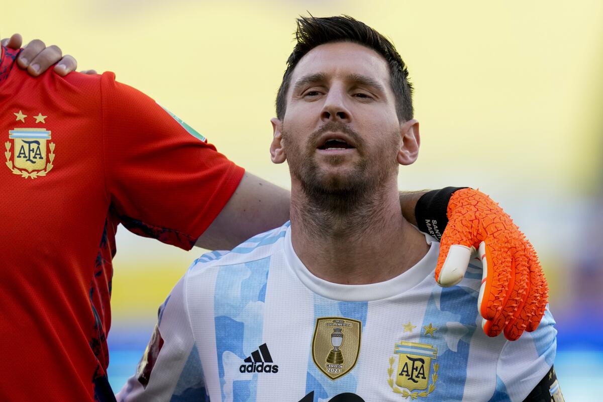 Argentina's Lionel Messi, signs his national anthem prior to the start of a qualifying soccer match for the FIFA World Cup Qatar 2022 against Brazil in Sao Paulo, Brazil, Sunday, Sept.5, 2021. Argentina walked off the field shortly after the start of the South American classic when health officials came onto the pitch following coronavirus concerns about some Argentina players.(AP Photo/Andre Penner)
