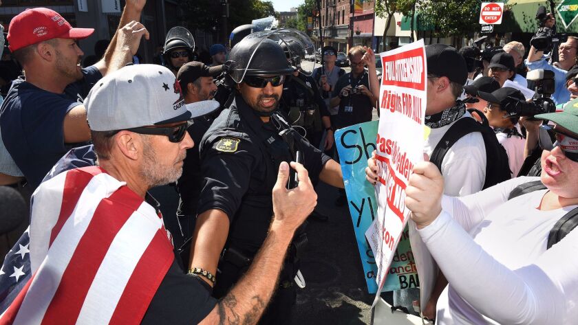 A police officer separates political sides as they argue before a speech by Milo Yiannopoulos in Berkeley last month.