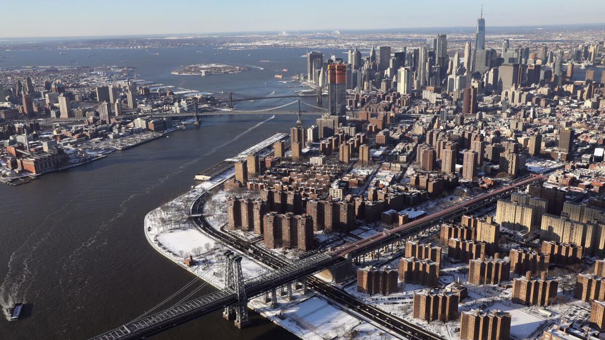 The toll-free Williamsburg Bridge stretches across the East River into Manhattan.