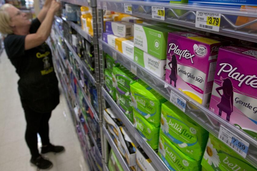 FILE - In this June 22, 2016 file photo, Tammy Compton restocks tampons at Compton's Market, in Sacramento, Calif. Gov. Jerry Brown on Tuesday, Sept. 13, 2016 rejected an attempt to waive taxes on tampons and other feminine hygiene products along with other proposed tax breaks, saying lawmakers should propose such ideas as part of the annual state budget process rather than as one-off exceptions. (AP Photo/Rich Pedroncelli,File)