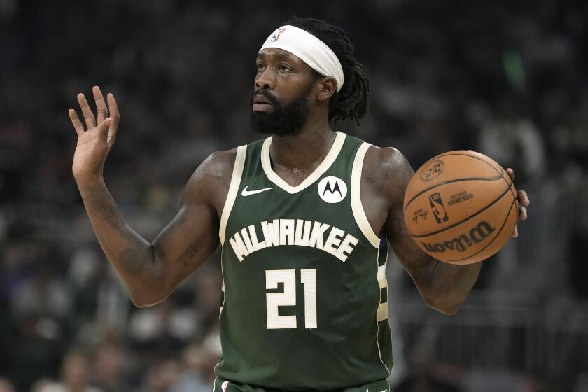 Milwaukee Bucks' Patrick Beverley holds up his hands while the ball in his left hand