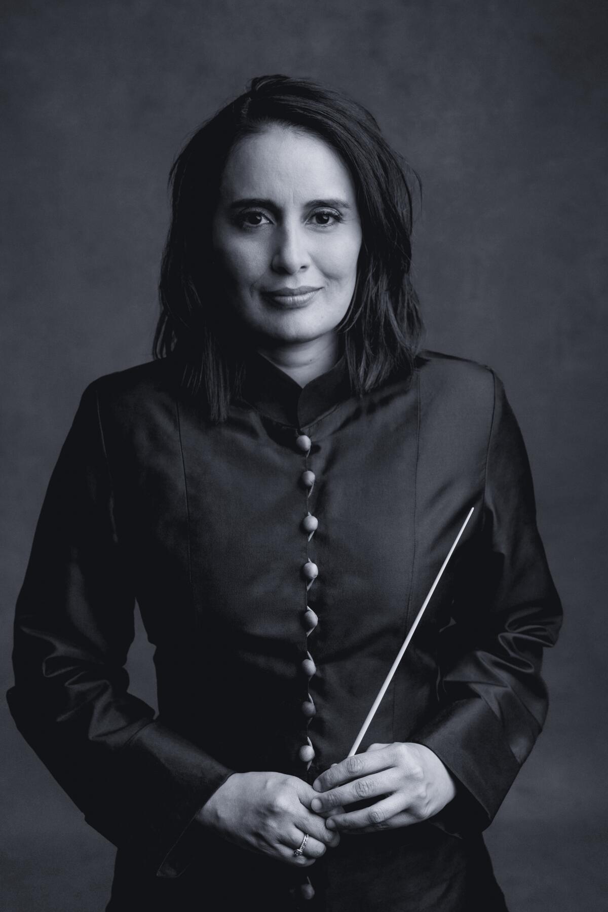 A woman with a conducting baton