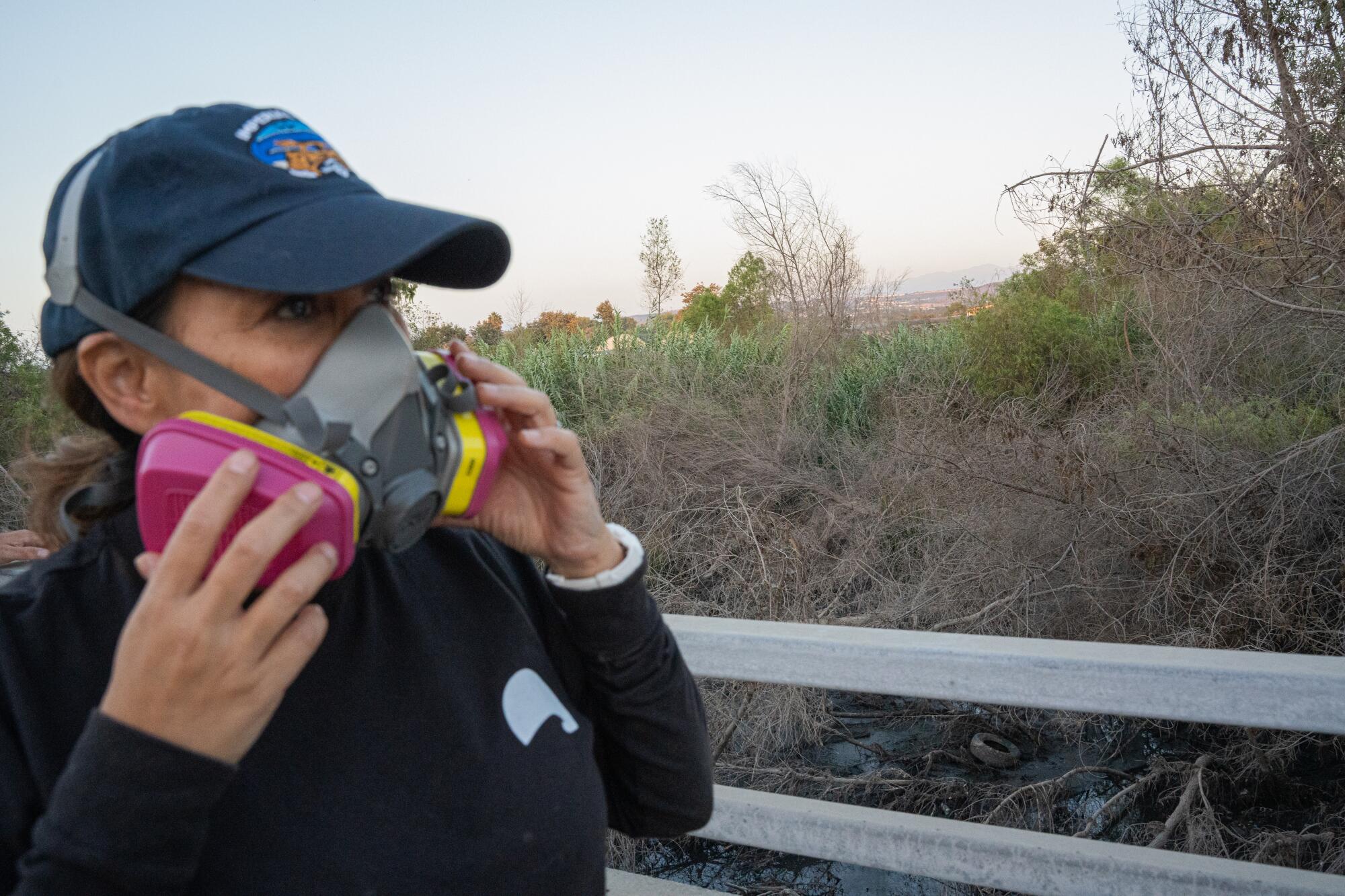 Mayor Paloma Aguirre wears a respirator mask