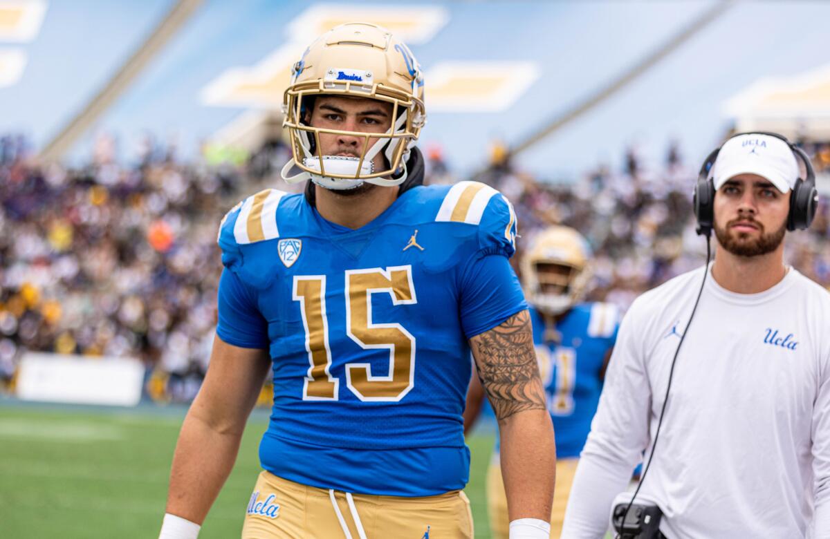 UCLA's Laiatu Latu stands on the sideline at the Rose Bowl